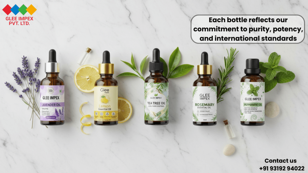 A high-quality flat-lay of Lavender, Lemon, Tea Tree, Rosemary, and Peppermint oil bottles by Glee Impex Pvt. Ltd., an Essential oil exporter, surrounded by fresh botanical ingredients on a marble surface.