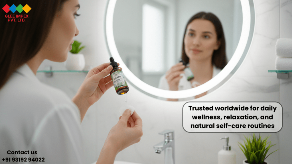 A woman incorporating natural oils from Glee Impex Pvt. Ltd., a global Essential oil exporter, into her daily self-care and skincare routine in a modern bathroom setting.