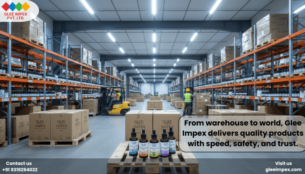 A massive, organized warehouse with palletized stock ready for global distribution by Glee Impex, a large-scale essential oil exporter in India.